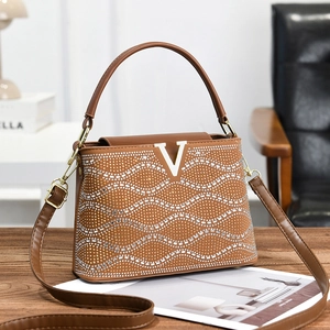 Brown sparkling rhinestone handbag with V-shaped metal logo and adjustable shoulder strap