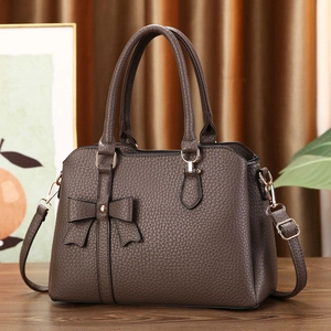 Litchi pattern dark brown handbag with bow detail and adjustable shoulder strap