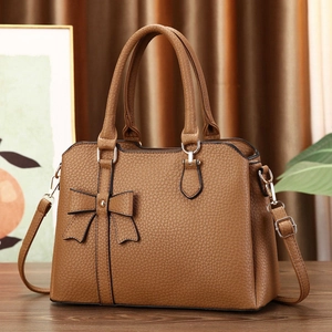 Brown litchi grain handbag with bow decoration and adjustable gold-tone shoulder strap