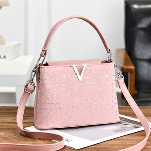 Pink faux leather tote bag with silver V-logo and sparkling geometric rhinestone details