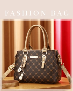 Detail of coffee monogram tote bag with champagne gold handle and pearl bell charm