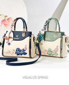 Detail of floral embroidery on vintage handbags with silk scarf and gold hardware
