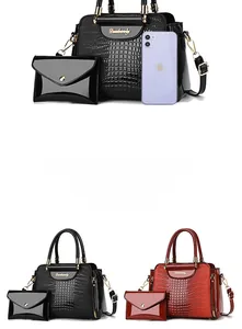 Detailed view of crocodile embossed leather tote bag set with matching envelope clutch bag