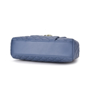 Detail shot of navy blue quilted leather handbag base with premium stitching texture