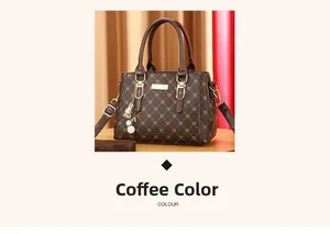 Detail of coffee brown monogram handbag with golden plaque and plush charm accessory