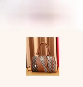 Detailed view of Boston bag with monogram jacquard fabric and brown leather handles