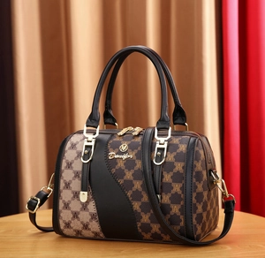 Detailed macro view of the Boston handbag showing golden metal zippers and stitching
