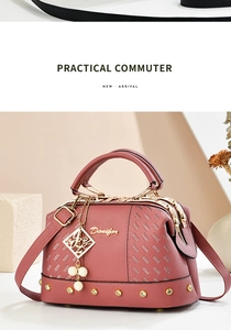 Close-up of pink lychee leather handbag with golden metal frame and pearl charm