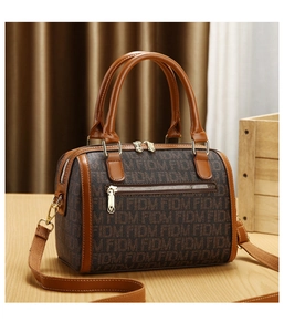 Detail of Boston bag featuring brown FIDM monogram jacquard and gold-tone hardware zipper