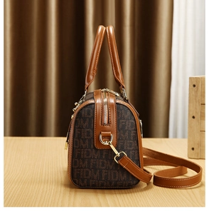 Detail shot of Boston style handbag with FIDM logo print and golden hardware details