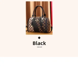 Detailed view of Boston bag with golden Danfor logo and brown monogram pattern