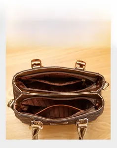 Macro view of brown monogram handbag interior with multiple zipper compartments