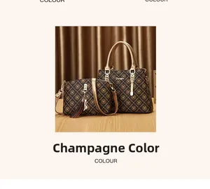 Detail of champagne two-piece bag set with M-monogram print, tassel and cat pendant