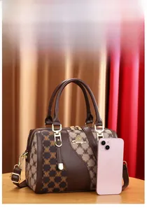 Detail of Boston bag showing brown monogram jacquard texture and golden Denifer logo