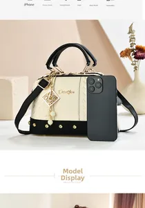 Detail of Boston handbag featuring contrast stitching and pearl pendant for daily use