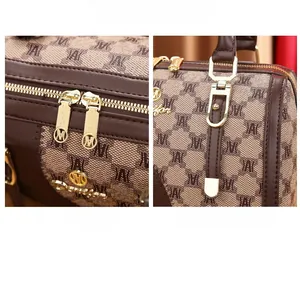 Detail of premium golden dual zipper and reinforced handle stitching on Boston bag