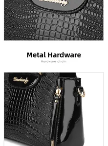 Detail view of crocodile pattern embossed leather bag with premium gold hardware and logo