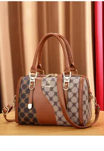 Detail of Boston handbag crafted from premium top grain leather and patterned fabric