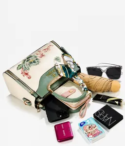 Detail of floral embroidery handbag showing spacious interior and daily essentials