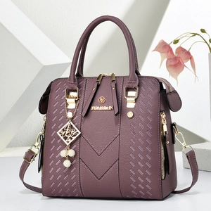 Detail of purple litchi leather Boston bag with V-shaped stitching and metal hardware