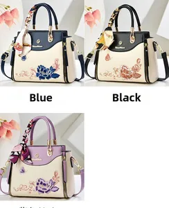 Detailed embroidery view of floral handbags in blue, black, and purple with silk scarves