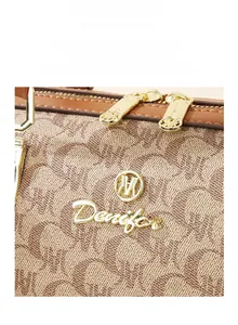 Macro detail of monogram jacquard fabric with premium gold hardware and zipper pull