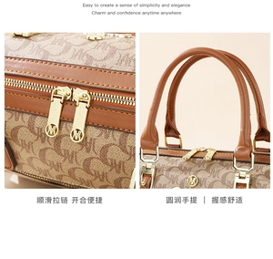 Detail of the golden metal zipper and brown leather handle on the monogram handbag
