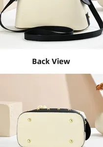 Detail of bottom protective gold studs and back view of two-tone pebbled leather handbag