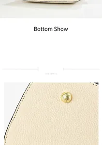 Detailed close-up of creamy faux leather texture and gold hardware on woman's handbag