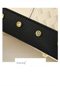 Detail showing cream woven texture, black lychee leather with gold rhinestones and studs