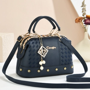 Elegant navy blue leather handbag with pearl charm and woven pattern detail