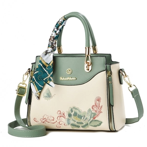 Elegant embroidered handbag with floral butterfly patterns and decorative silk scarf handle