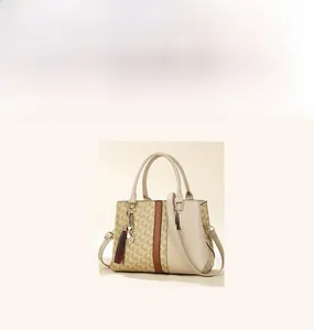 Detail of vintage monogram shoulder bag with tassel charm and textured beige finish