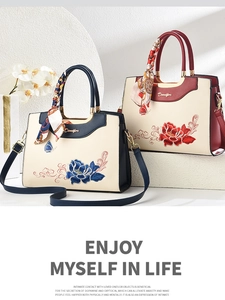 Macro shot of embroidered peony floral patterns on elegant leather handbags