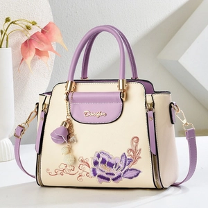 Elegant off-white leather handbag with purple floral embroidery and gold logo