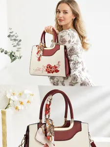 Makro-Detail von chinesischer Stickerei und Seidenschal-Griff an eleganter Tasche