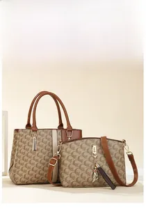 Close-up of stylish brown monogram tote bag set with metal tassel and crossbody bag