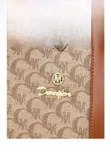 Close-up of Denifor monogram fabric handbag with premium gold metal logo and leather trim