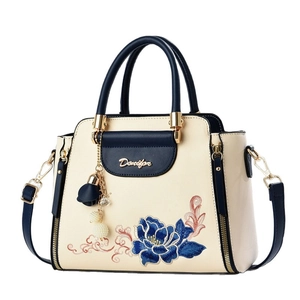 Denifor embroidered floral handbag in cream and navy blue with pearl tassel charm