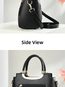 Detail view of black woven tote with gold hardware and adjustable shoulder strap