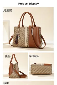 Detail view of brown leather tote bag with tassel charm and bottom metal feet