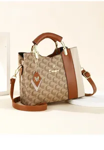 Detailed close-up of TOGO top layer cowhide handbag with M-pattern and metal logo