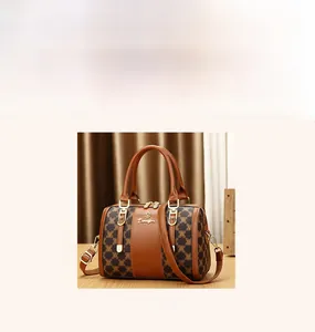 Detail view of caramel brown Boston bag with classic monogram print and leather texture