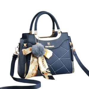 Navy blue textured leather handbag with silk scarf, pompom charm and gold hardware