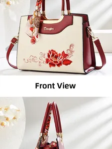 Detail of red flower embroidery and silk scarf on beige Chinese style handbag