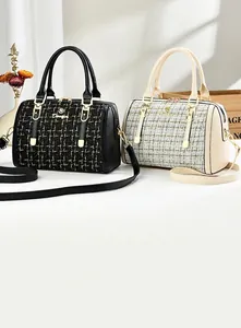 Detail of tweed Boston pillow bags with gold M hardware and detachable straps