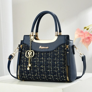 Elegant navy blue woven tweed and leather handbag with gold hardware and pearl charm