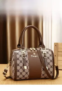 Detail of Boston bag with vintage monogram canvas and brown leather stitching handles