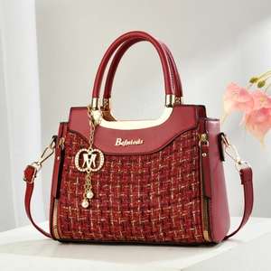 Red tweed woven handbag with golden hardware and adjustable leather shoulder strap