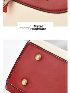 Close-up of litchi grain leather texture and golden metal feet on red handbag